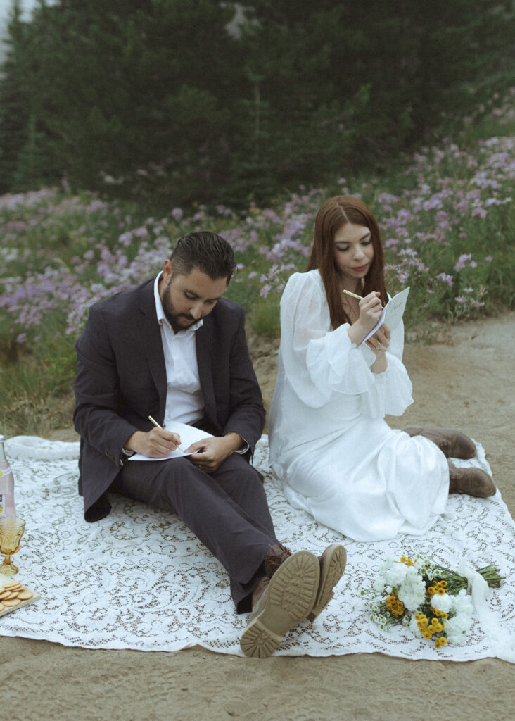 bride and groom writing their vows for their silver forest trail elopement 