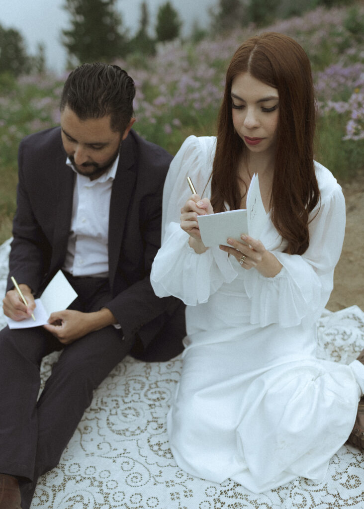 bride and groom writing their vows for their silver forest trail elopement 