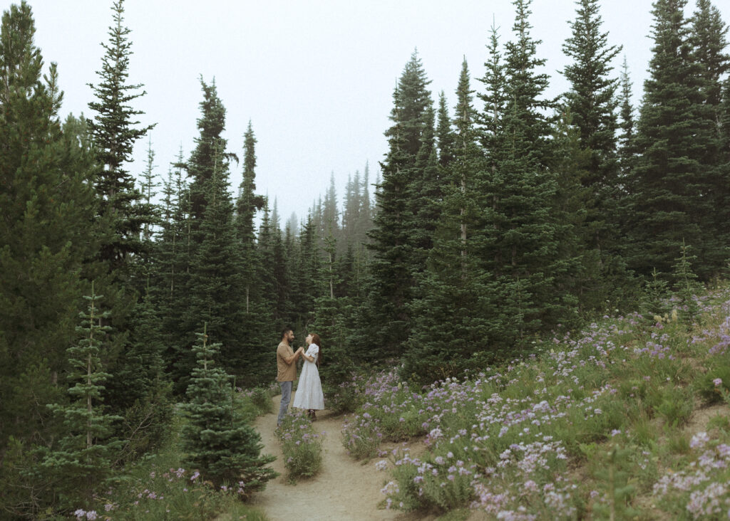 bride and groom taking photos in their casual outfit for their silver forest trail elopement 