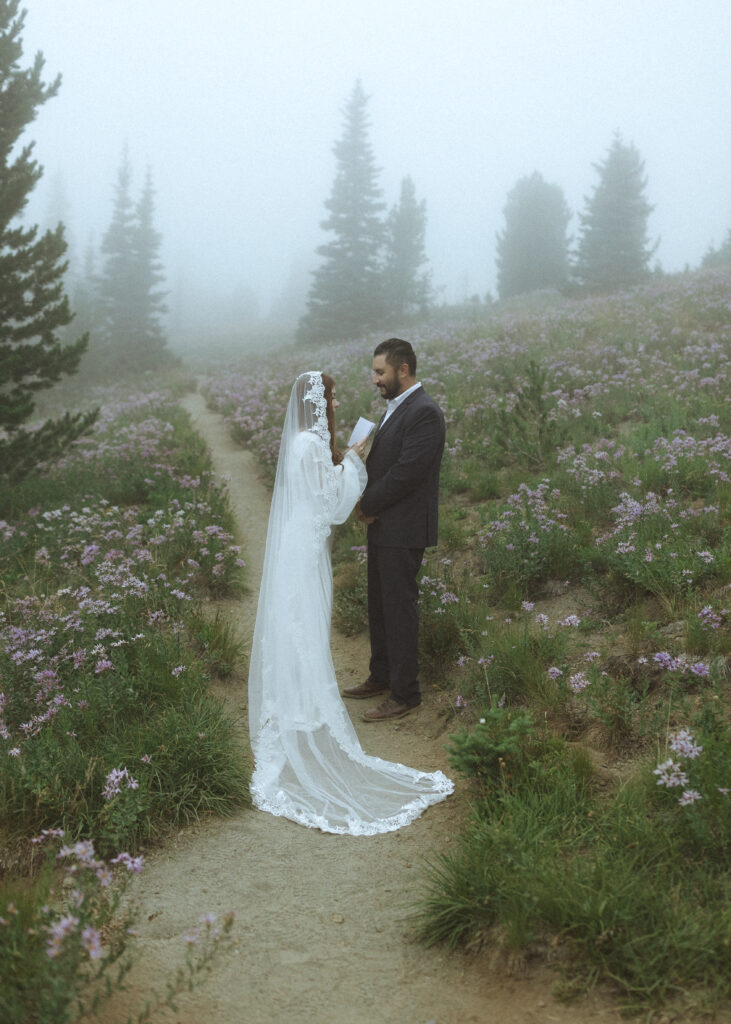 bride and groom reading their vows for their silver forest trail elopement 