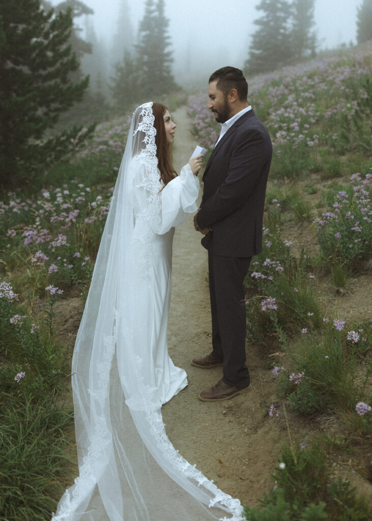 bride and groom reading their vows for their silver forest trail elopement 