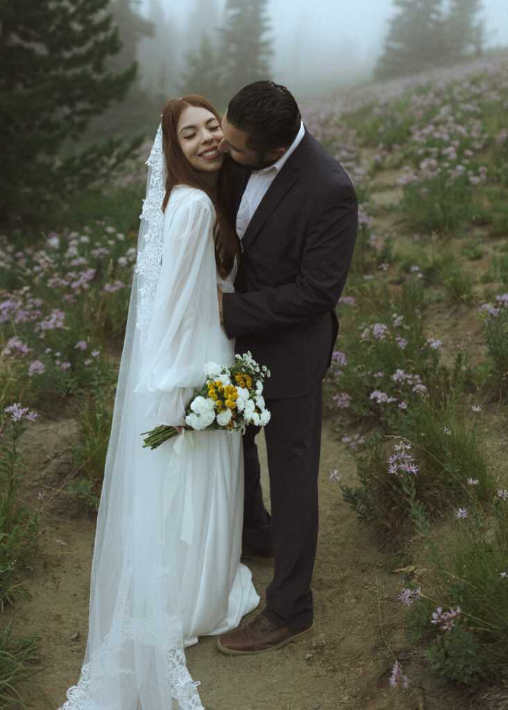 bride and groom taking photos at their silver forest trail elopement 