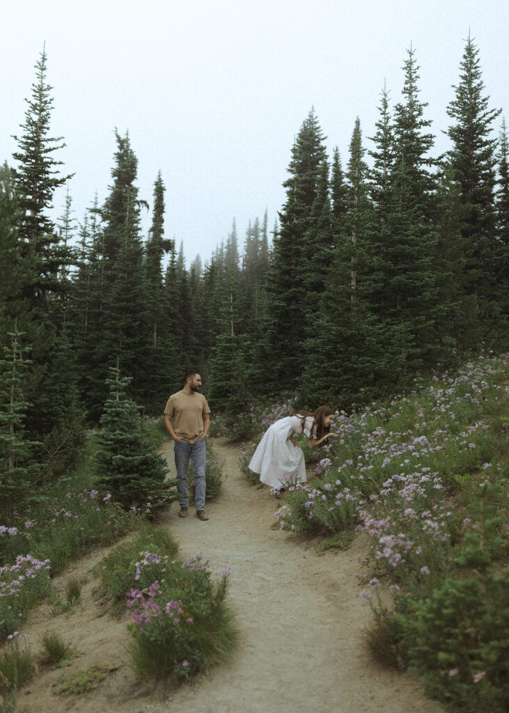 bride and groom taking photos in their casual outfit for their silver forest trail elopement 