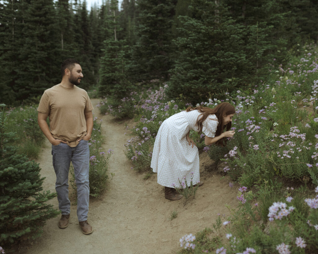 bride and groom taking photos in their casual outfit for their silver forest trail elopement 