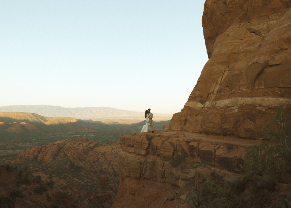 bride and groom taking photos for their Cathedral Rock Elopement 