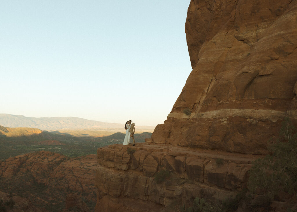 bride and groom taking photos for their Cathedral Rock Elopement 