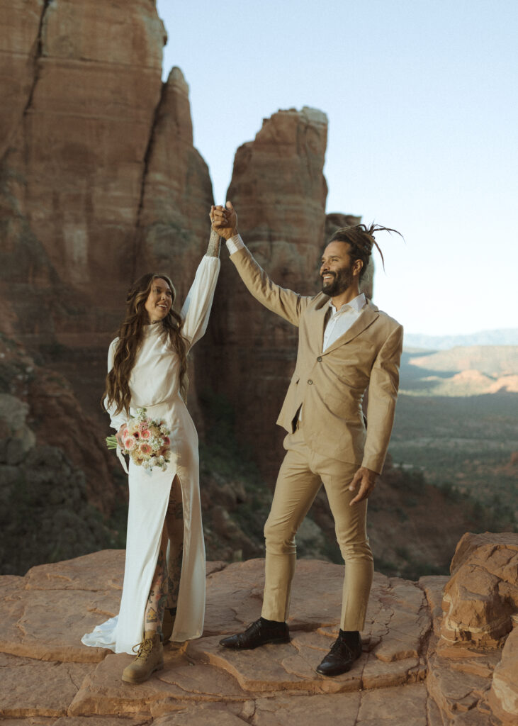 bride and groom taking photos for their Cathedral Rock Elopement 