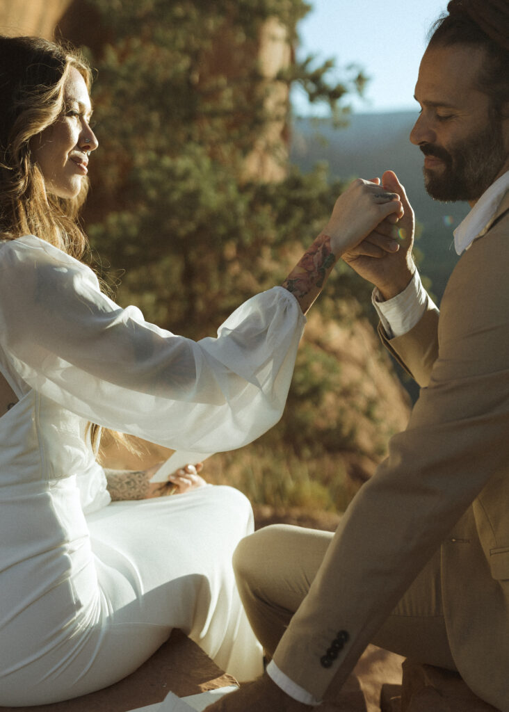 bride and groom writing vows  for their Cathedral Rock Elopement 