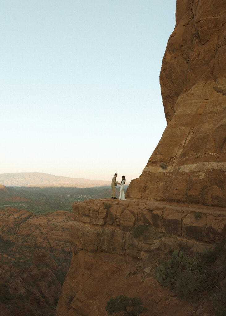 bride and groom taking photos for their Cathedral Rock Elopement 