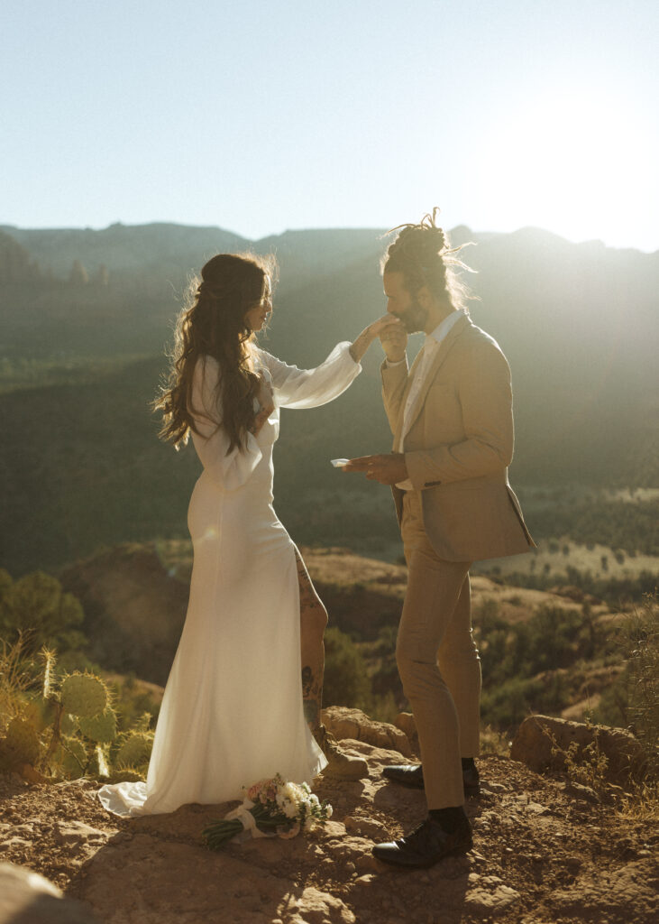 bride and groom reading vows  for their Cathedral Rock Elopement 