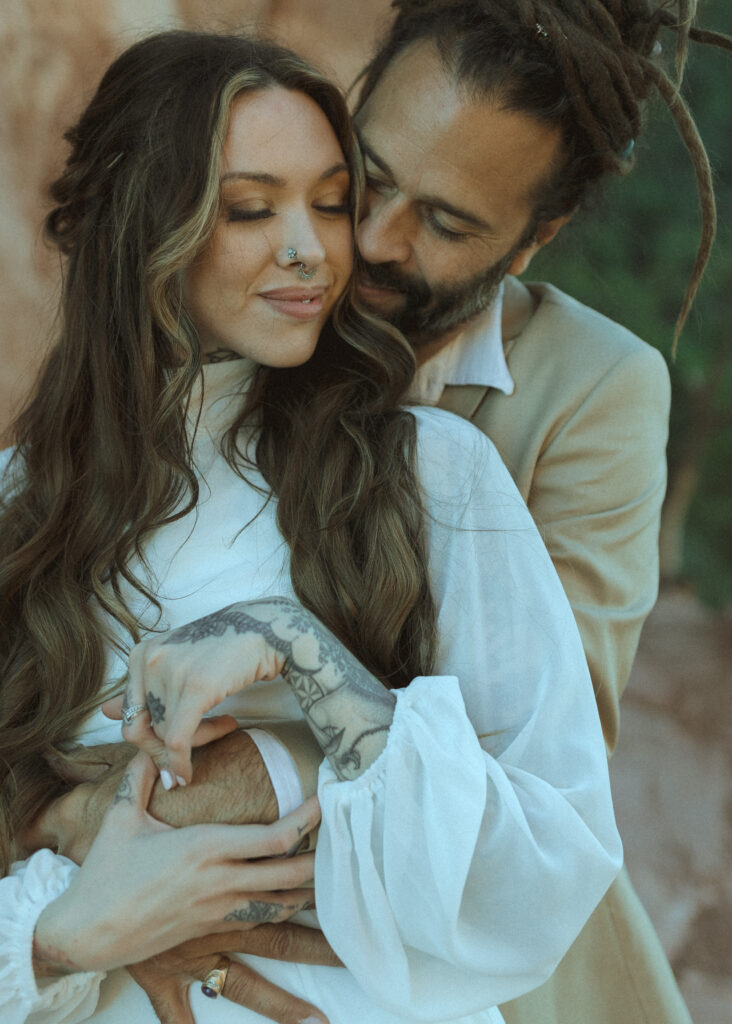 bride and groom taking photos for their Cathedral Rock Elopement 