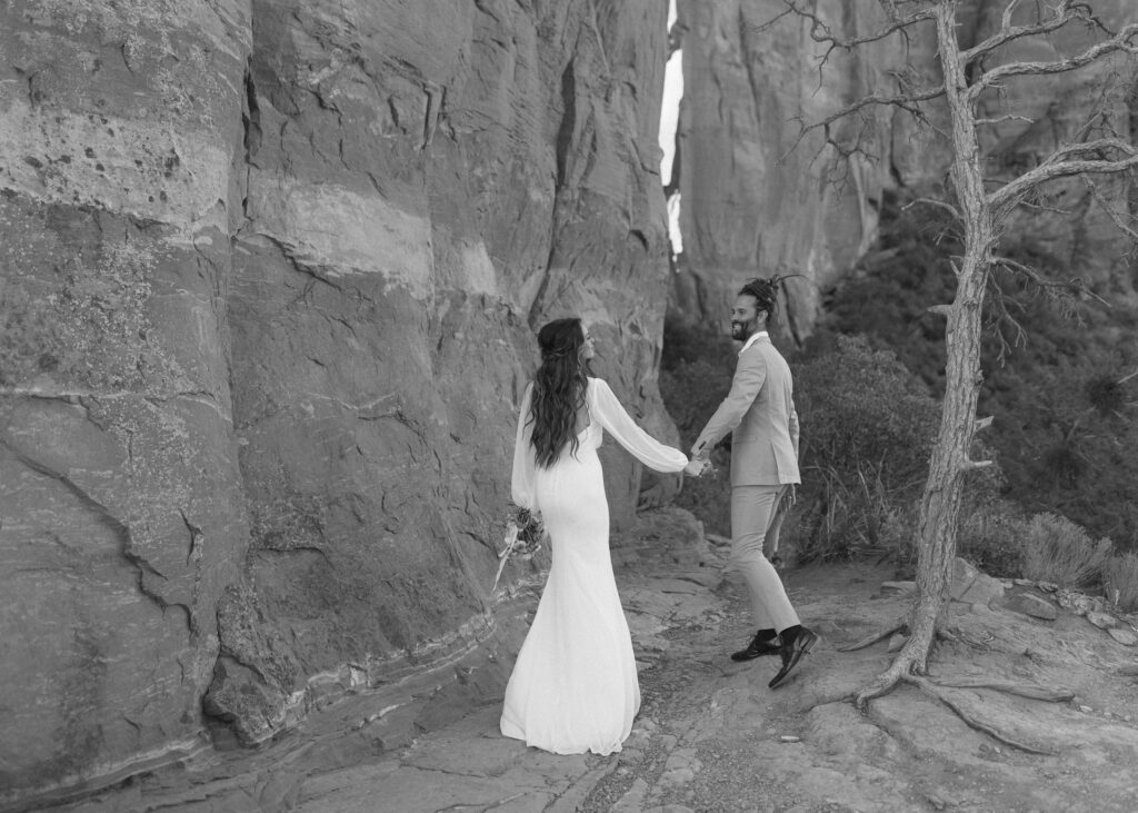 bride and groom taking photos for their Cathedral Rock Elopement 