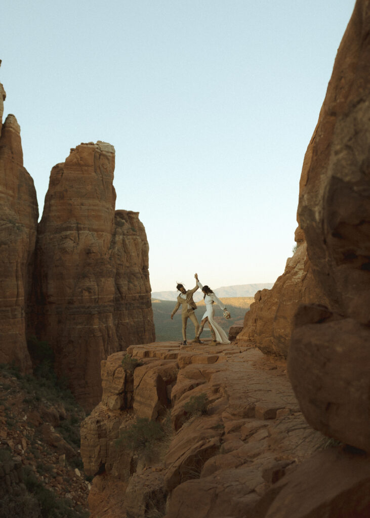 bride and groom taking photos for their Cathedral Rock Elopement 