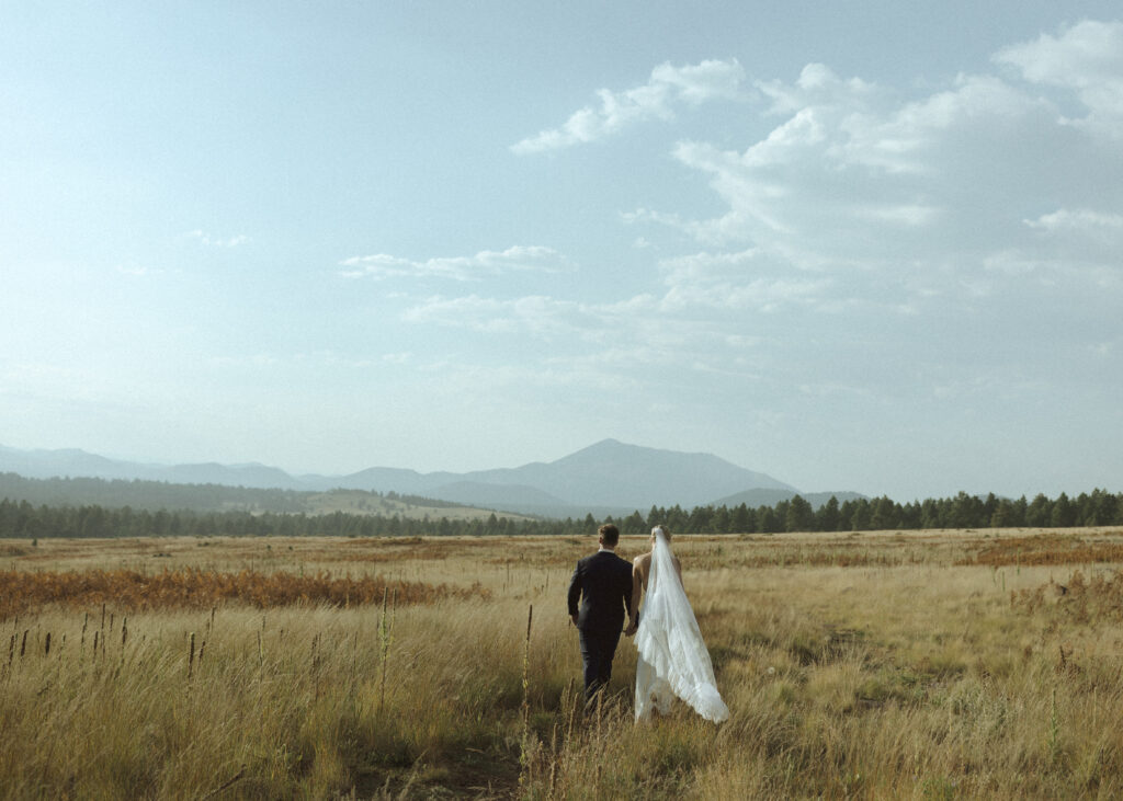 bride and groom walking for their fall flagstaff elopement