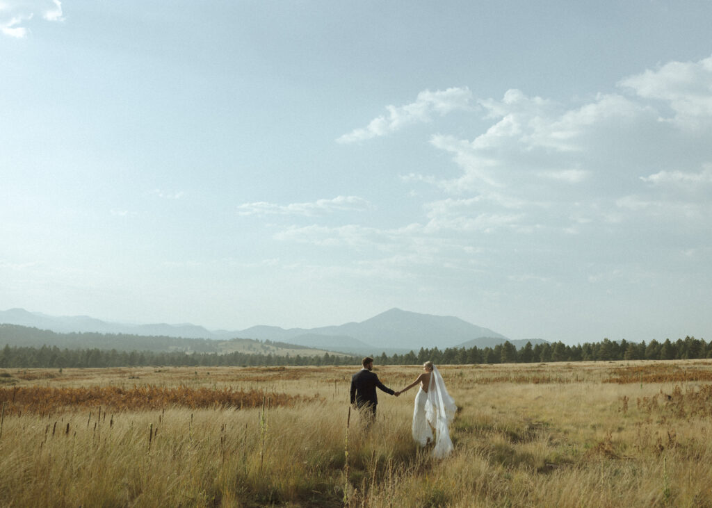 bride and groom walking for their fall flagstaff elopement