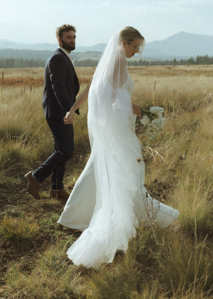 bride and groom walking for their fall flagstaff elopement