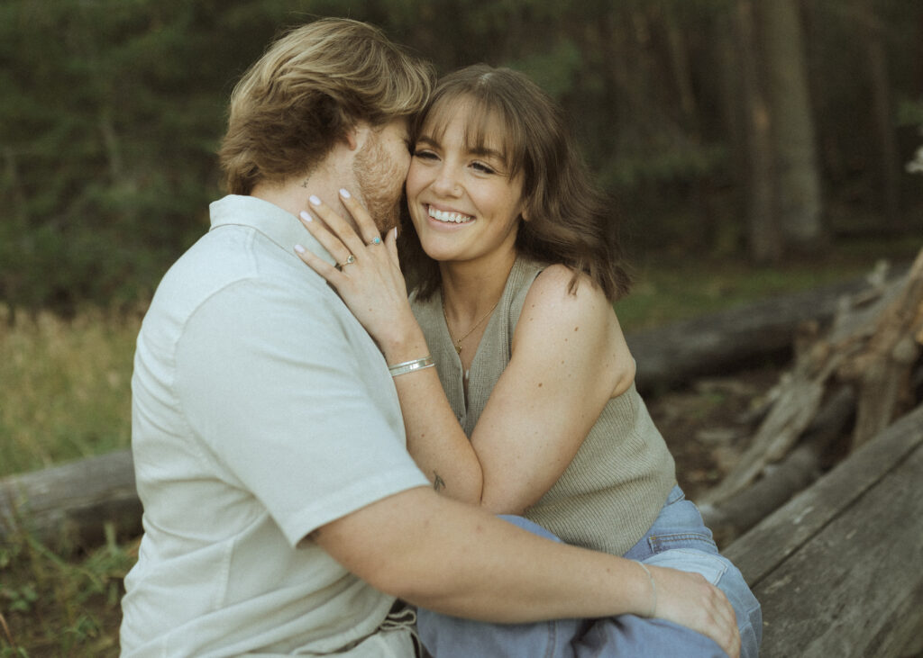 couple sitting on a log for their flagstaff engagement photos