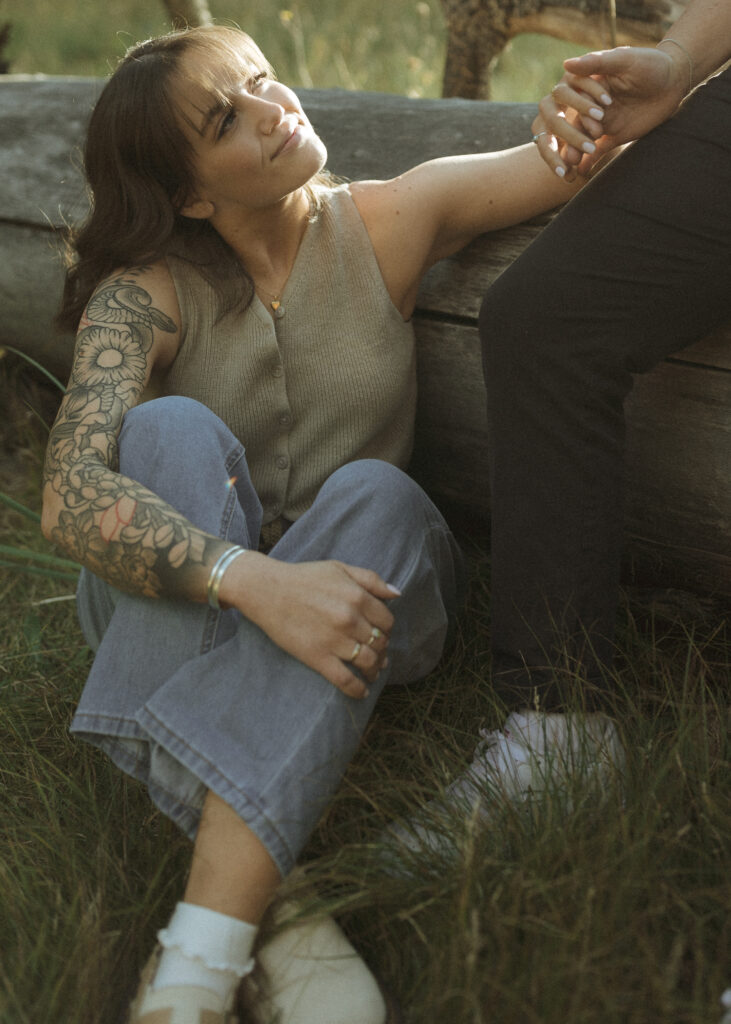 couple sitting on a log for their flagstaff engagement photos