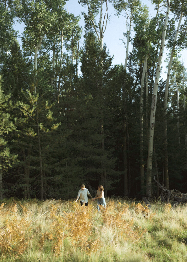 couple frolicking for their flagstaff engagement photos