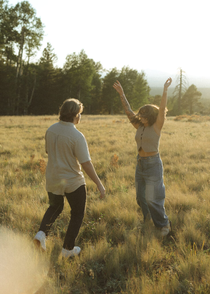 couple frolicking for their flagstaff engagement photos