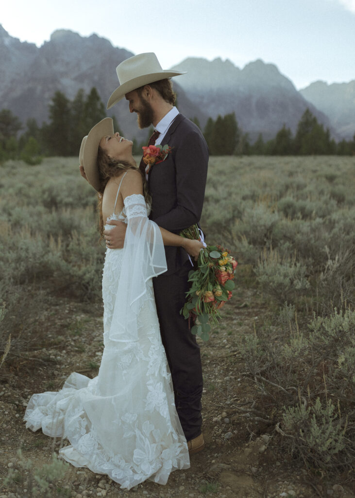 bride and groom taking sunset photos for their fall Grand Teton Elopement 