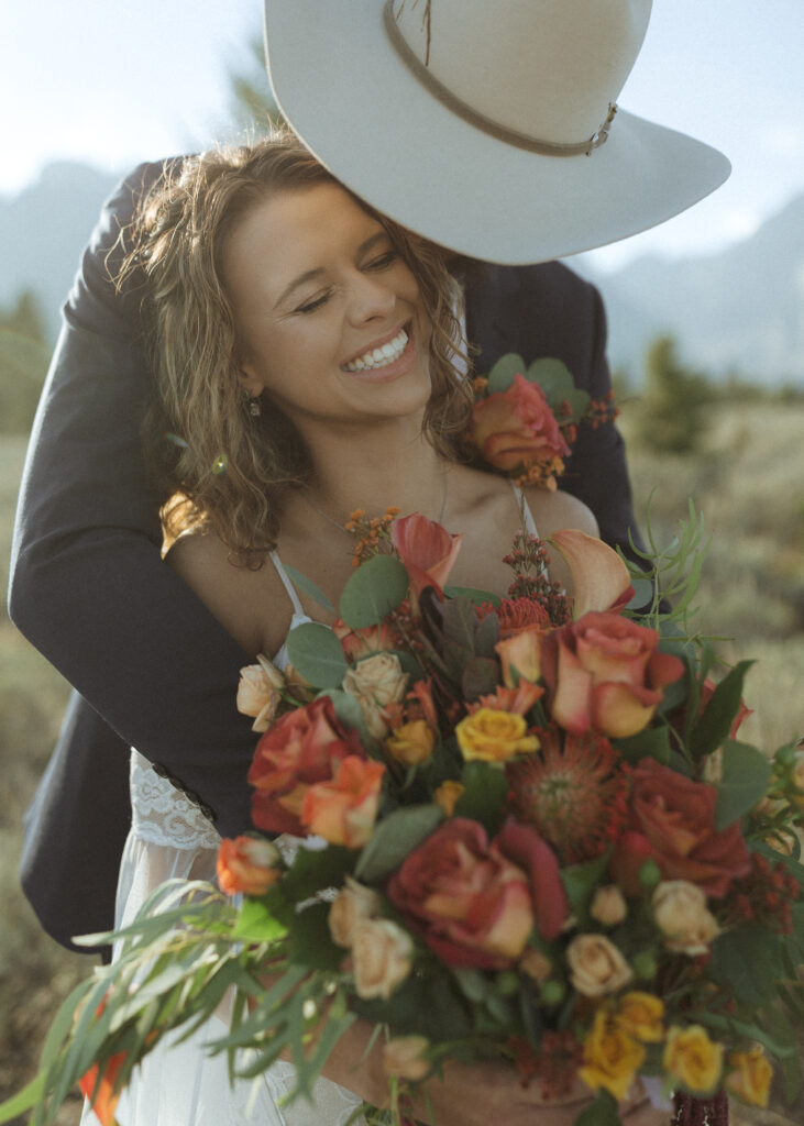 bride and groom taking sunset photos for their fall Grand Teton Elopement 