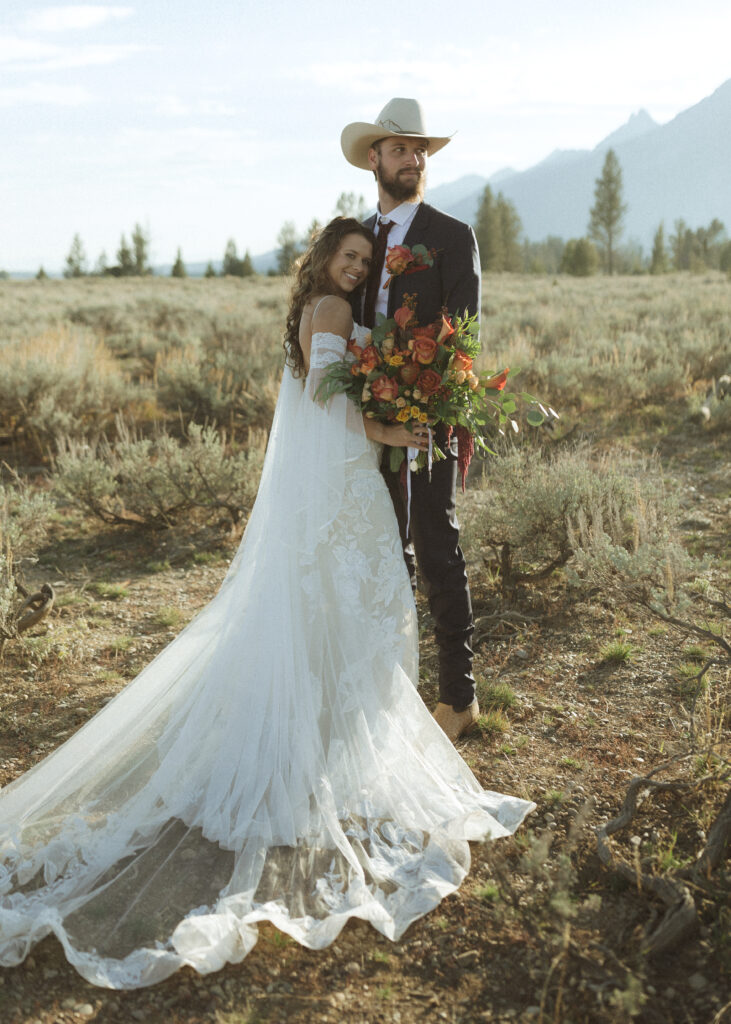 bride and groom taking sunset photos for their fall Grand Teton Elopement 