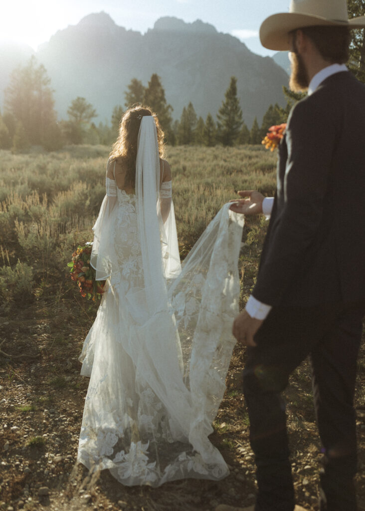 bride and groom taking sunset photos for their fall Grand Teton Elopement 