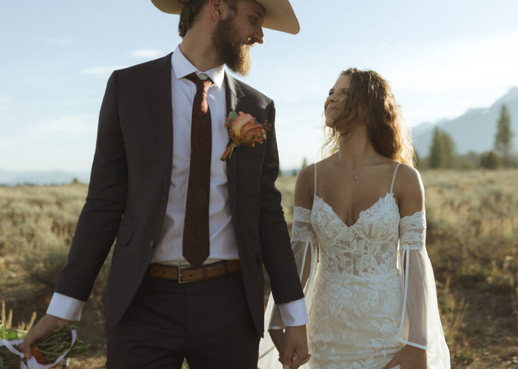 bride and groom taking sunset photos for their fall Grand Teton Elopement 