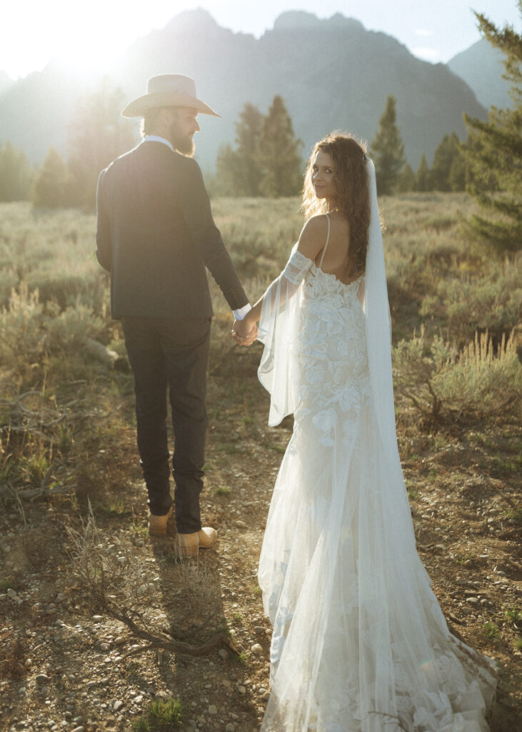 bride and groom taking sunset photos for their fall Grand Teton Elopement 