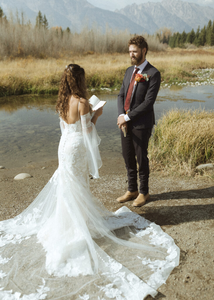 bride and groom reading their vows privately for their Grand Teton elopement 