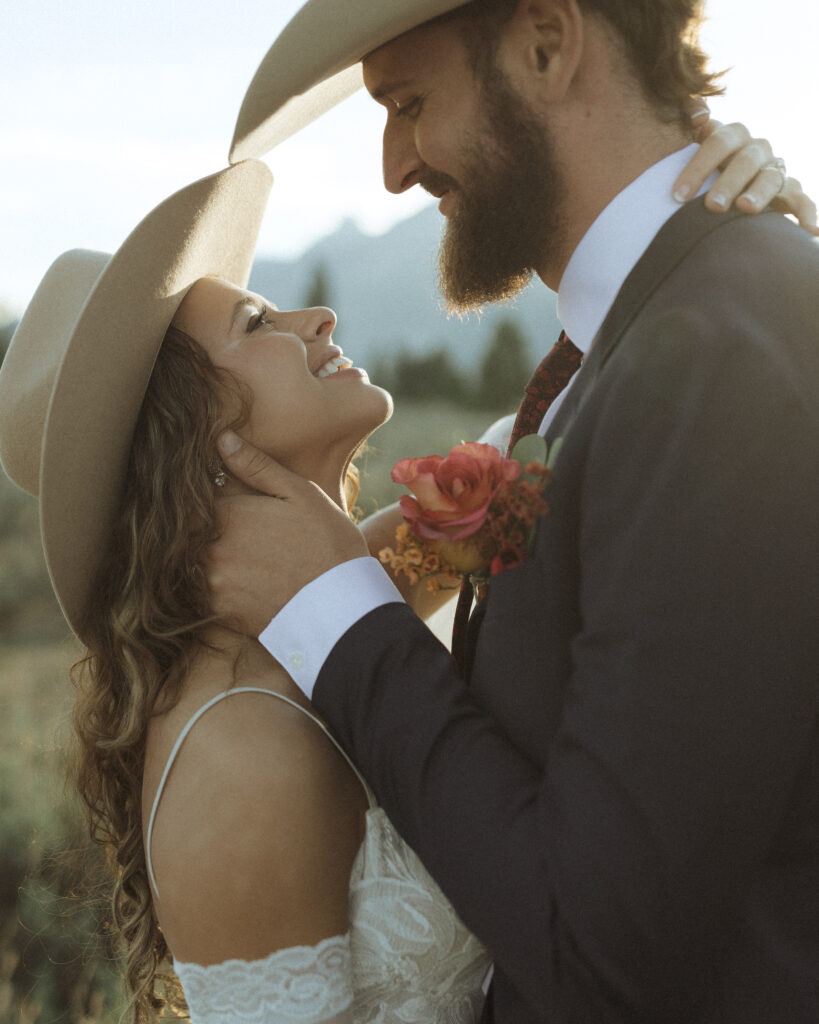 bride and groom taking sunset photos for their fall Grand Teton Elopement 