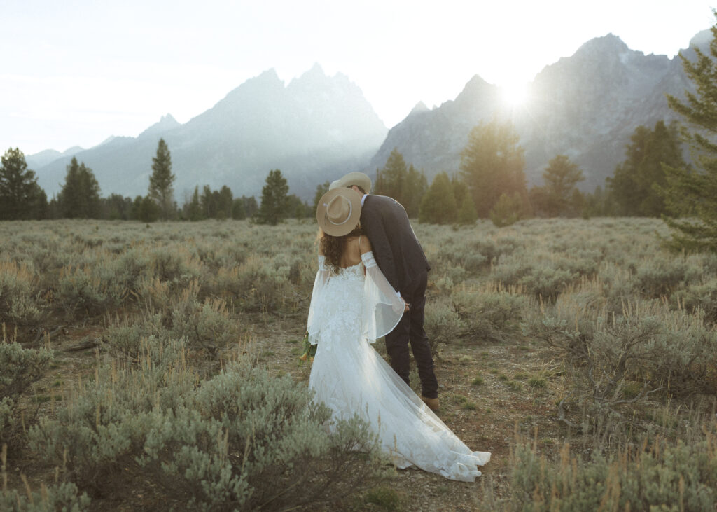 bride and groom taking sunset photos for their fall Grand Teton Elopement 