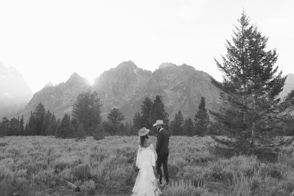 bride and groom taking sunset photos for their fall Grand Teton Elopement 