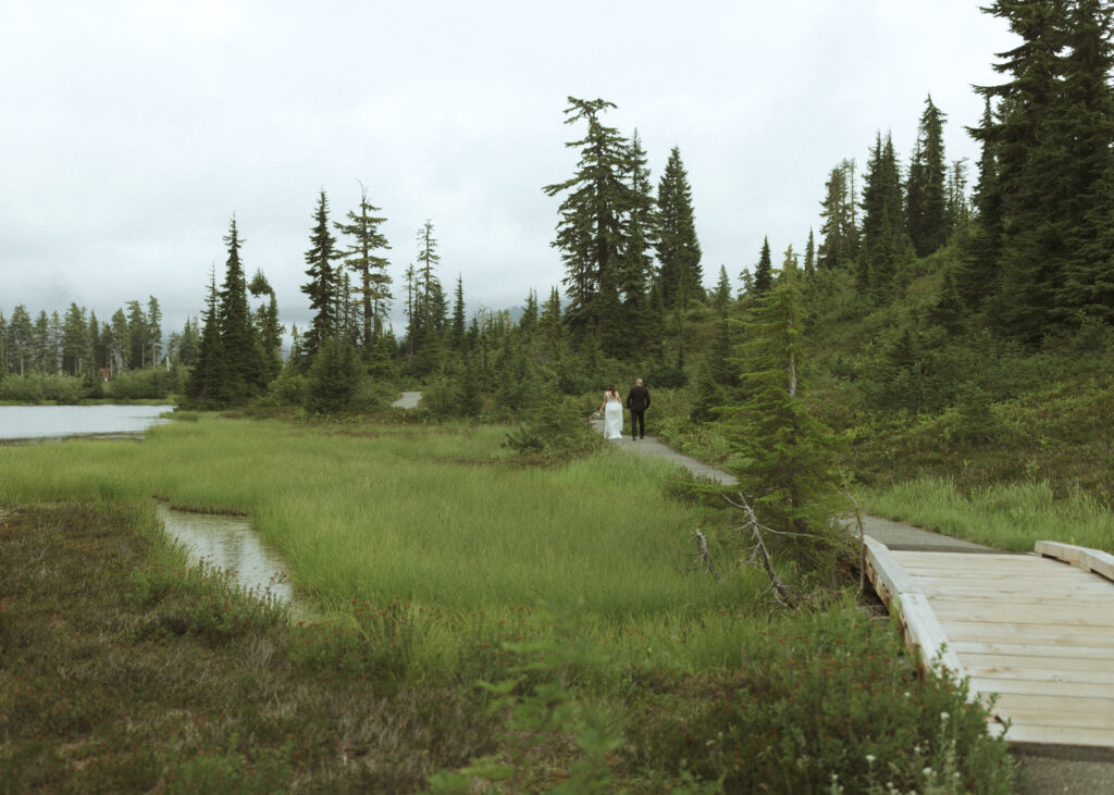 bride and groom walking on the trail for their Mount Baker Elopement 