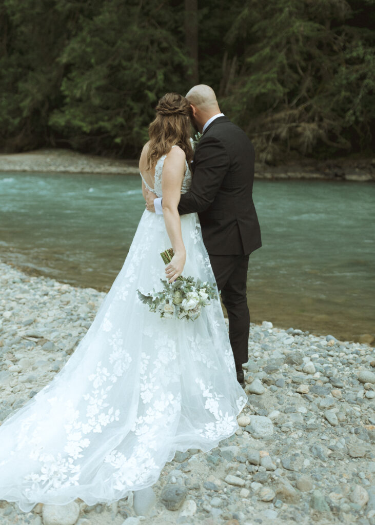 bride and groom reading their vows along the river for their Mount Baker Elopement 