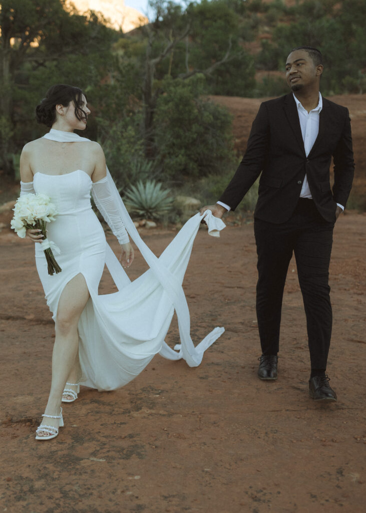 bride and groom taking photos for their bell rock sedona elopement 