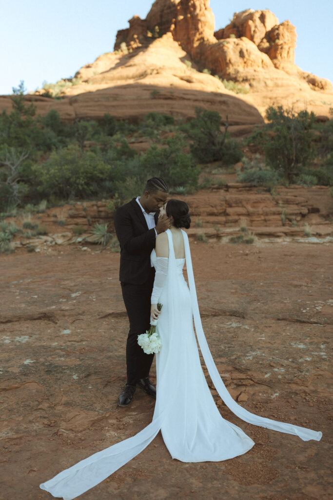 bride and groom taking photos for their bell rock sedona elopement 