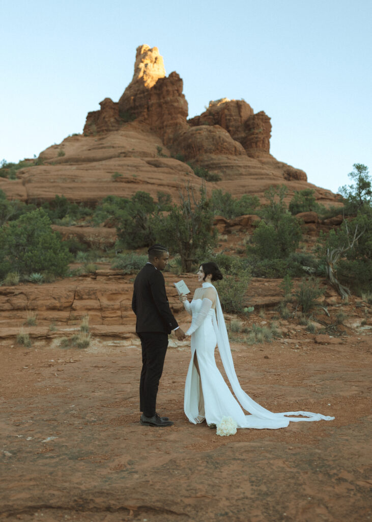 bride and groom exchanging vows for their bell rock sedona elopement 