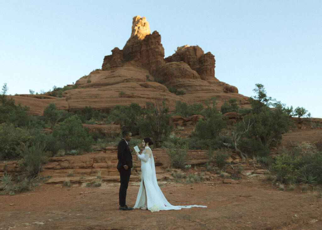 bride and groom exchanging vows for their bell rock sedona elopement 