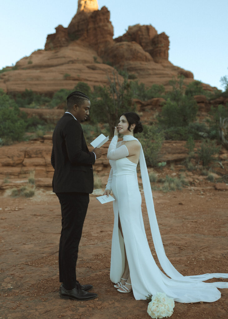 bride and groom exchanging vows for their bell rock sedona elopement 