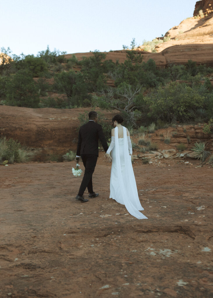 bride and groom taking photos for their bell rock sedona elopement 