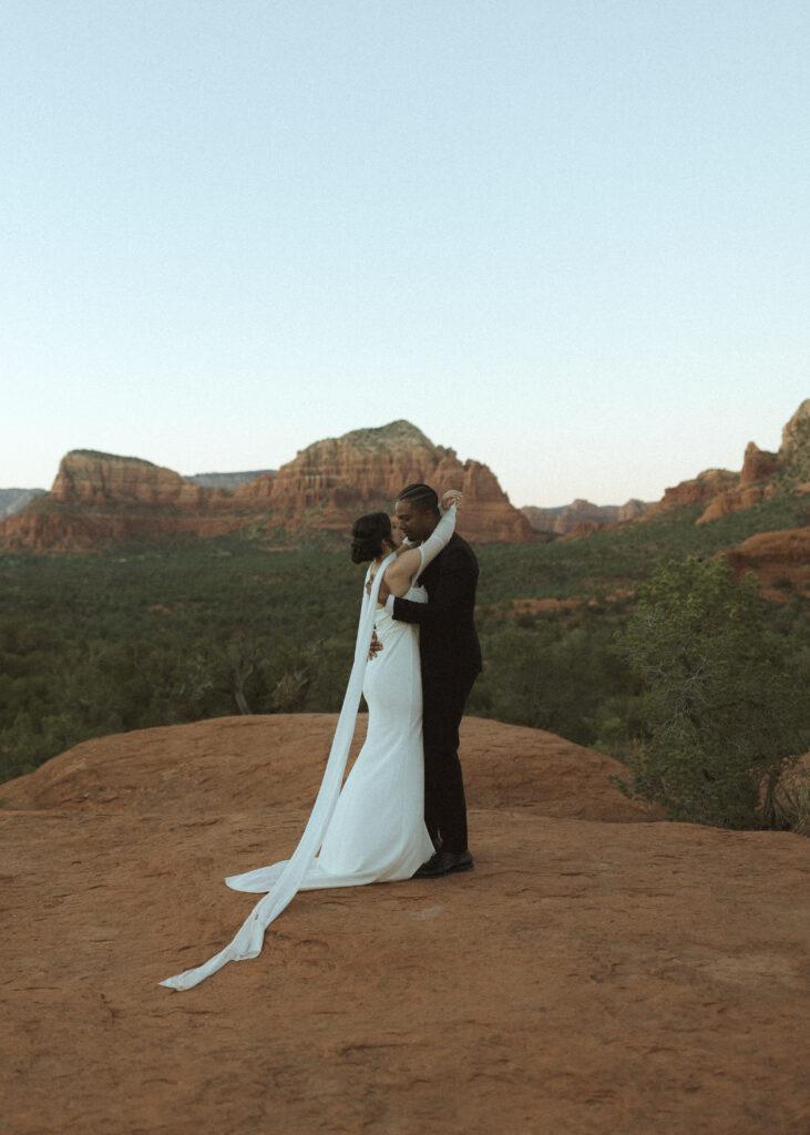 bride and groom taking photos for their bell rock sedona elopement 