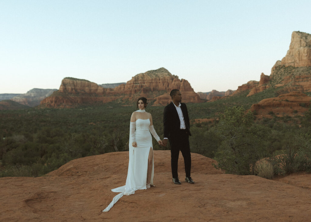 bride and groom taking photos for their bell rock sedona elopement 