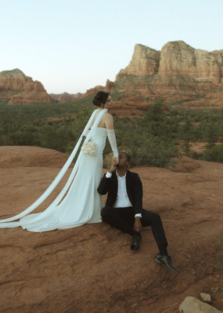 bride and groom taking photos for their bell rock sedona elopement 