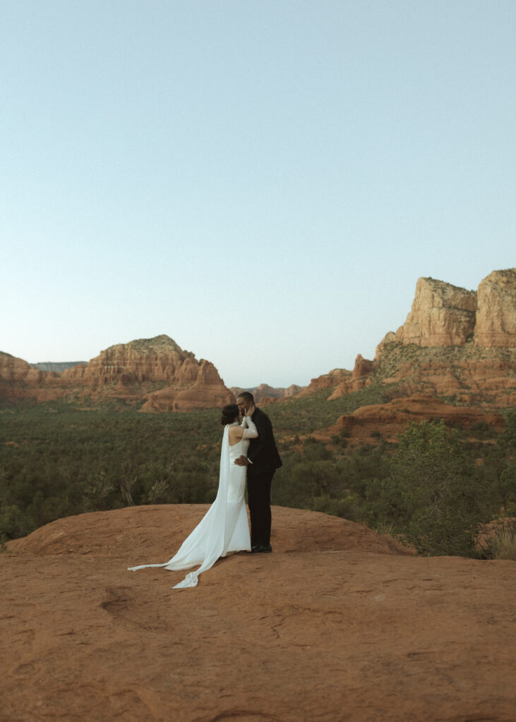 bride and groom taking photos for their bell rock sedona elopement 