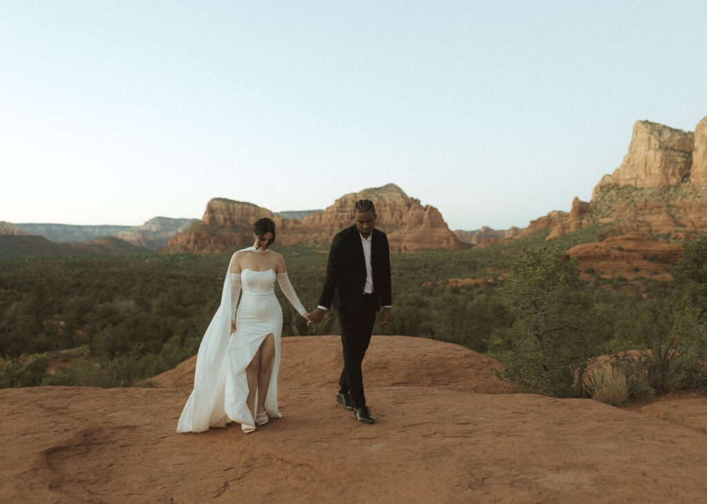 bride and groom taking photos for their bell rock sedona elopement 