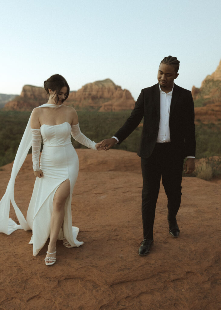 bride and groom taking photos for their bell rock sedona elopement 