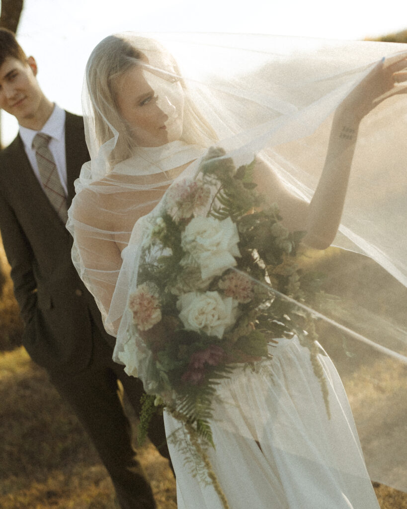 bride and groom taking photos for their Roca Ridge Events Wedding 