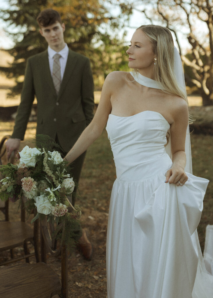 bride and groom taking photos for their Roca Ridge Events Wedding 